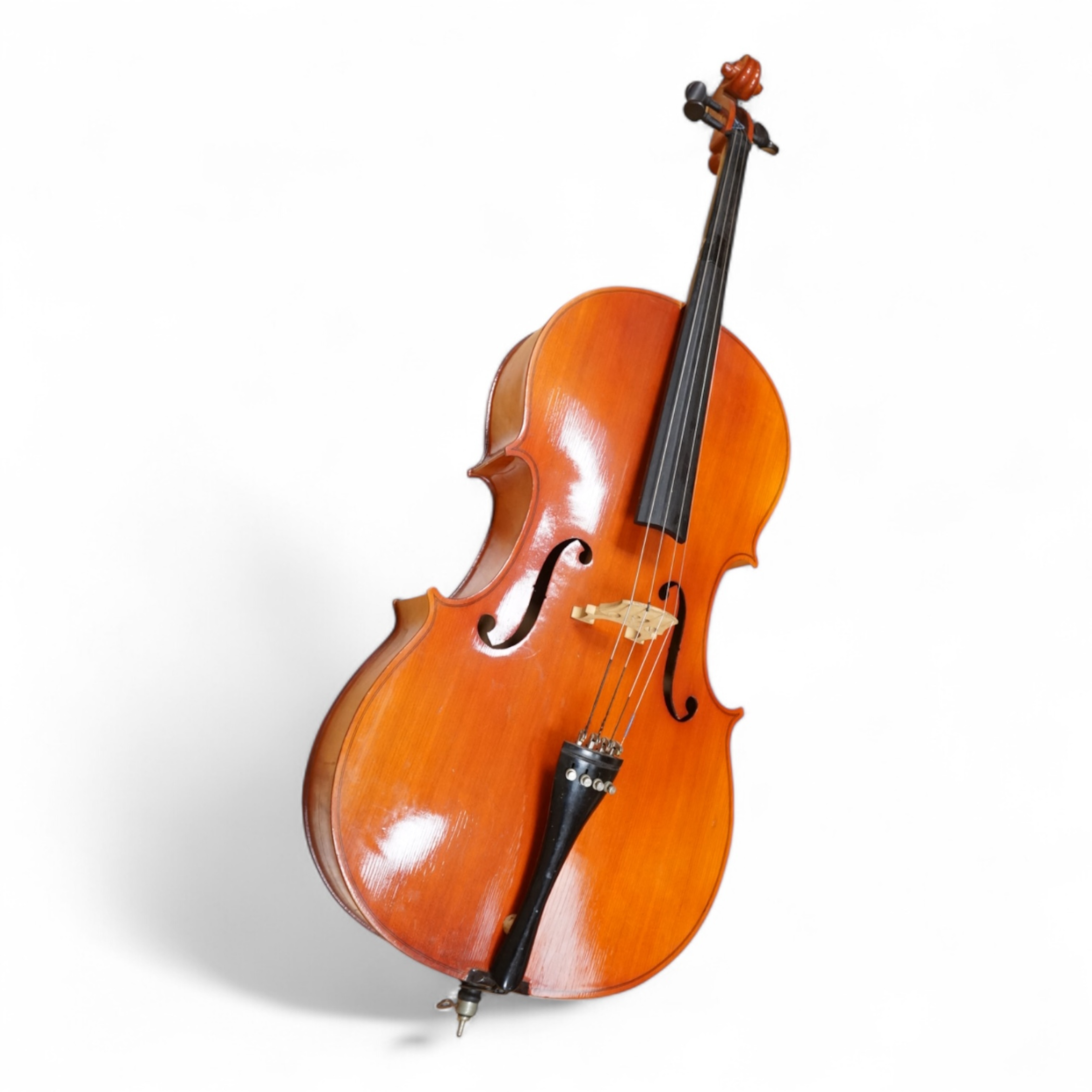 A modern student’s cello in a soft case and a student’s Spanish classical guitar
